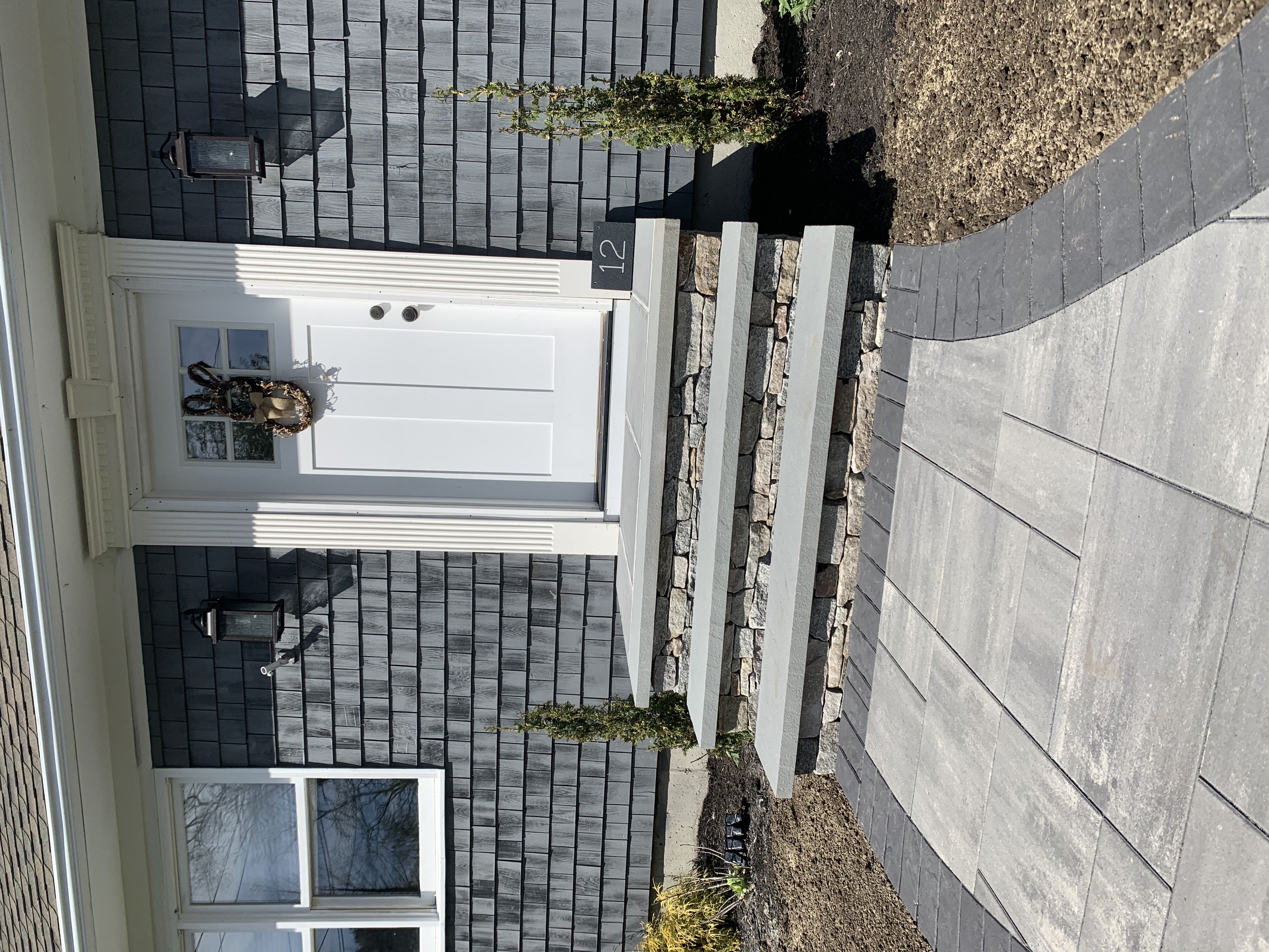 Bluestone walkway leading to coastal home entrance