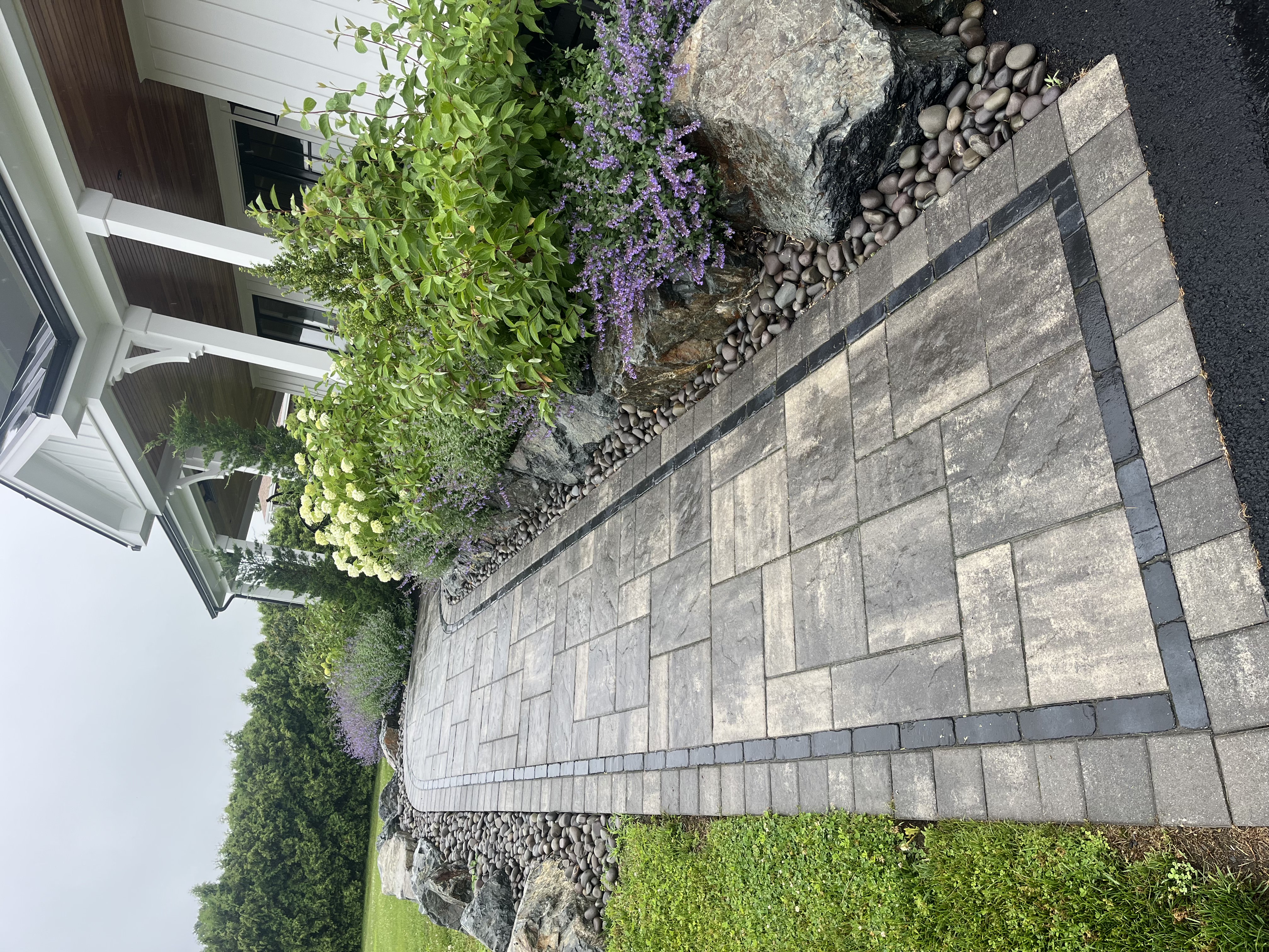 Fire pit patio with seating wall in Westerly backyard