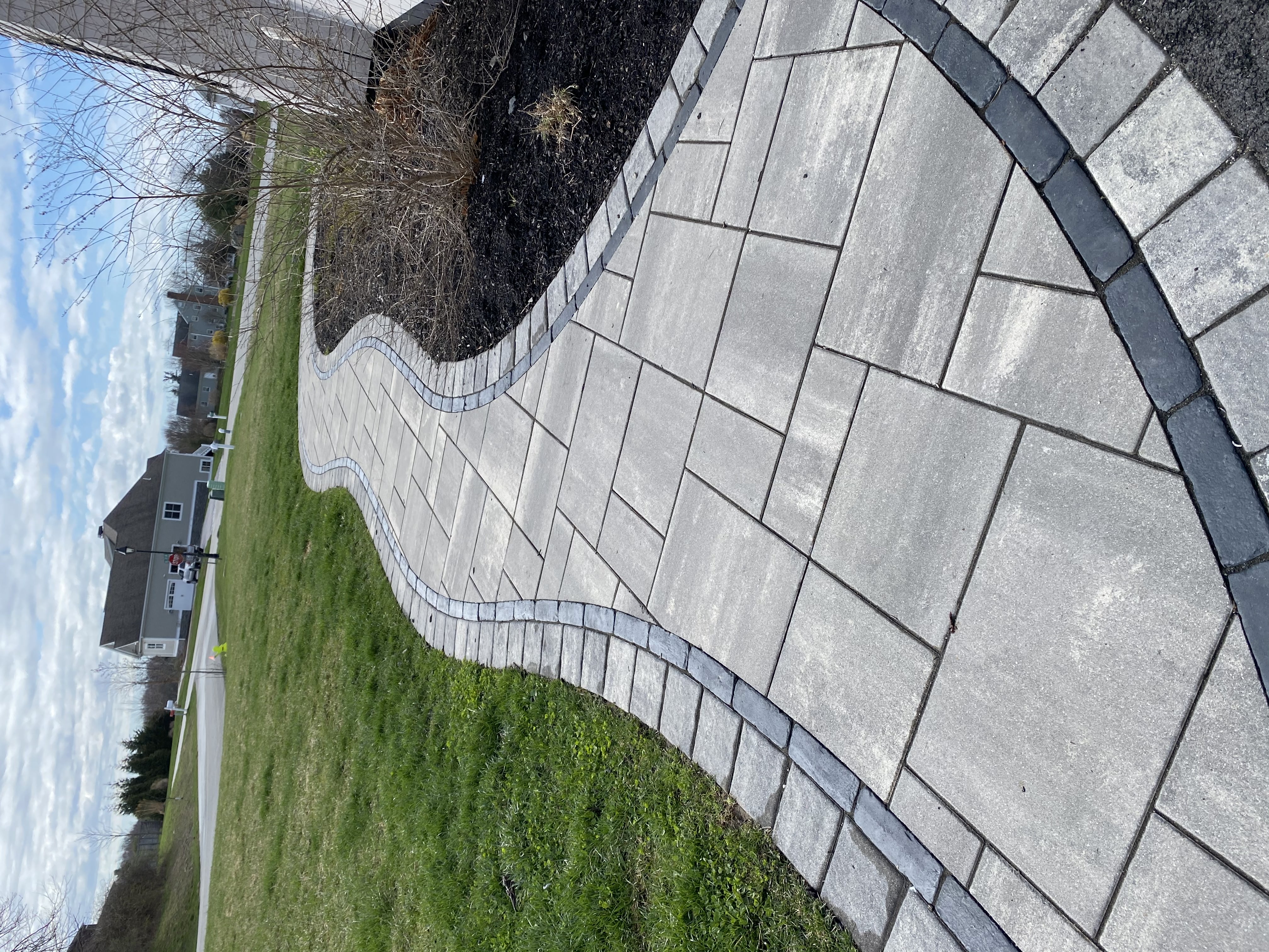 Completed hardscaping project with lush landscaping